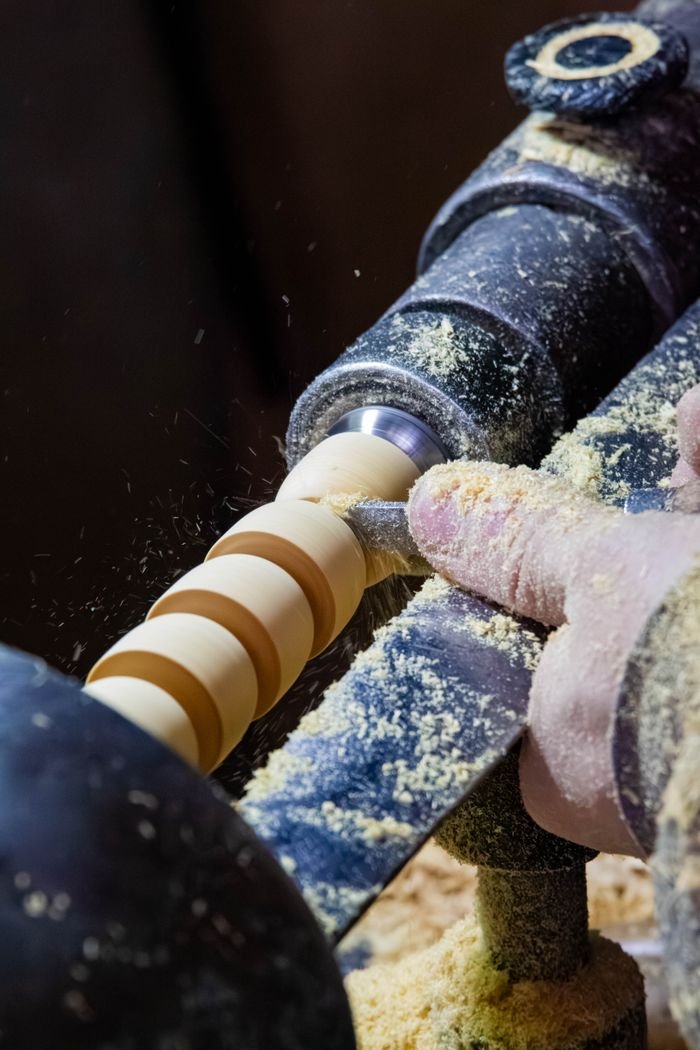 Close-up of woodturning on a lathe, showcasing traditional craftsmanship in Fes, Morocco.