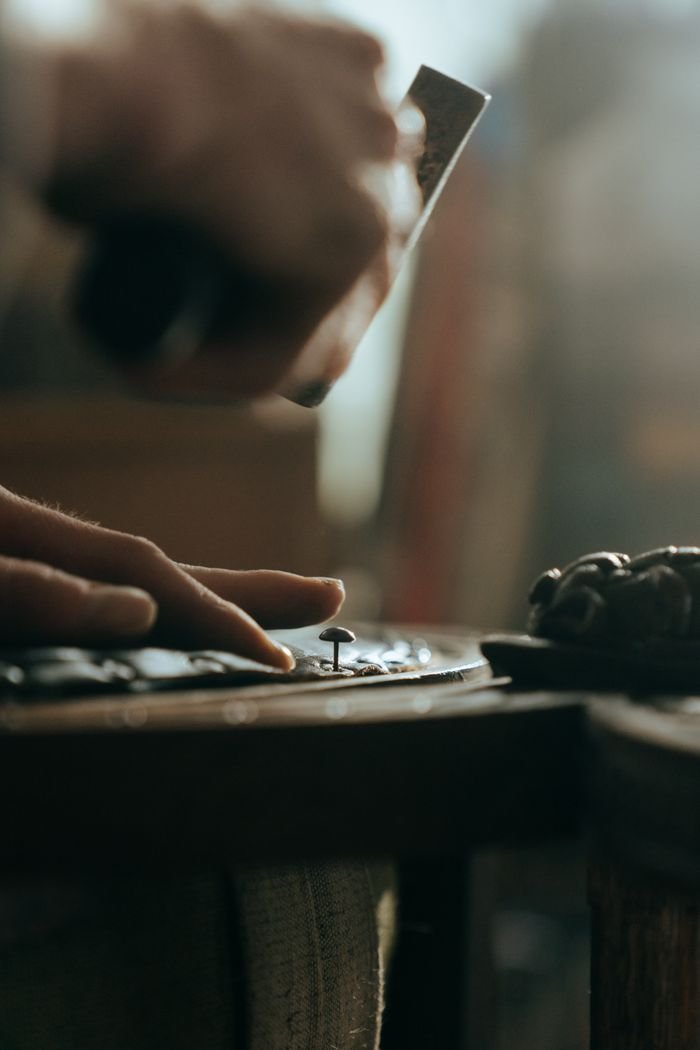 Close-up of a craftsman restoring wooden furniture with precision and skill.